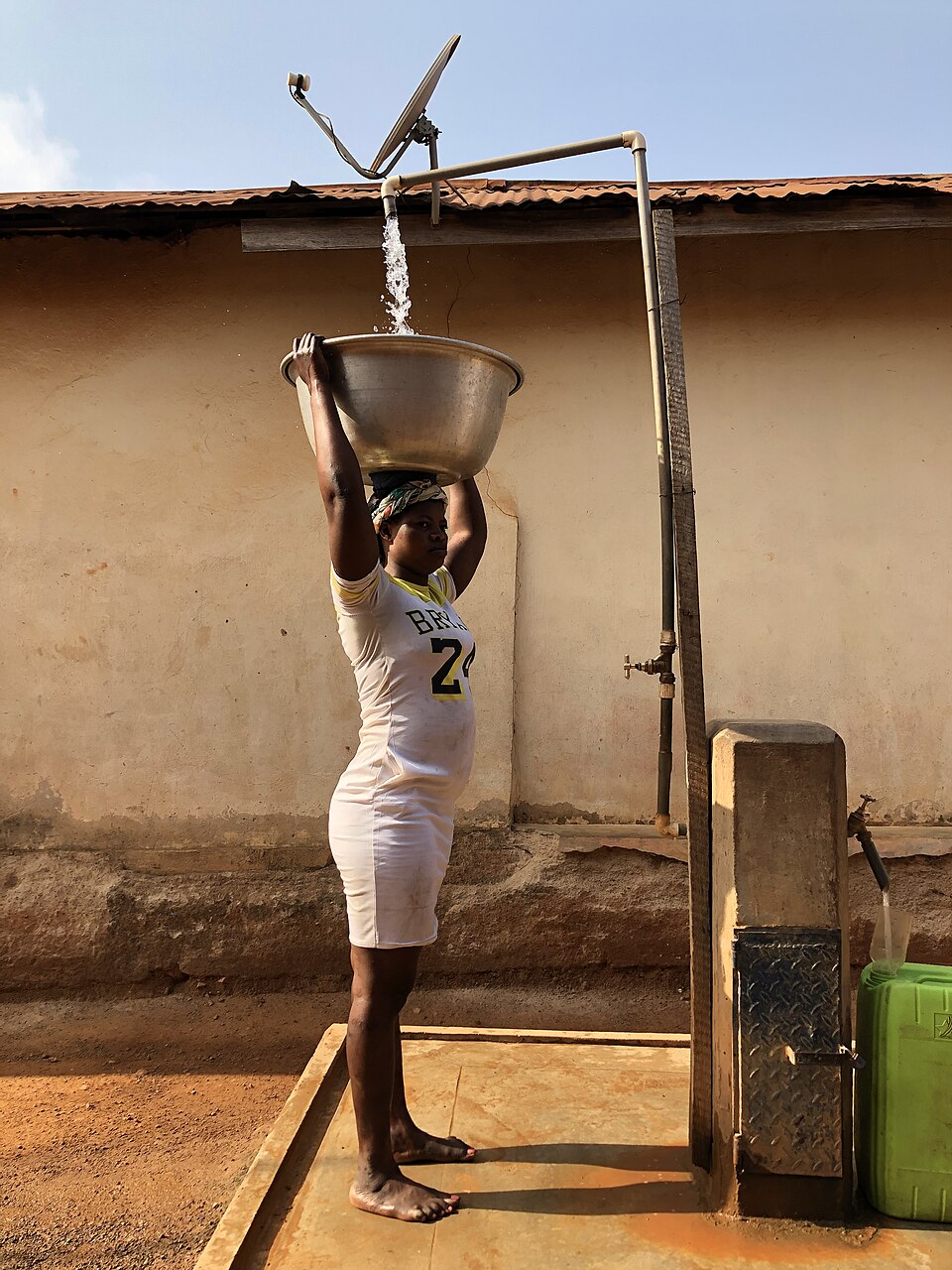 A woman fetching water at a standpipe in Ghana